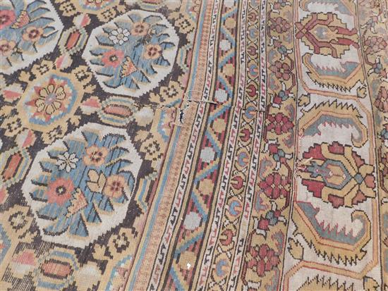 A large Indian carpet, circa 1910, 16ft 1in x 21ft 4in. (652cm x 491cm), fragment 5ft 11in. x 3ft 6in.